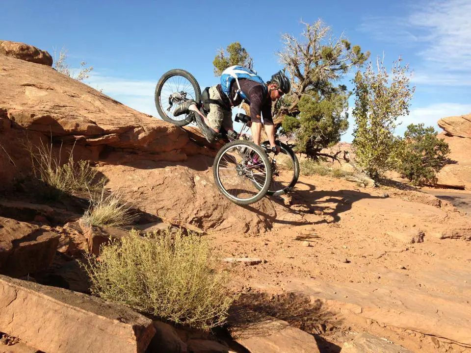 adaptive handcycle mountain bike, man going down on rocks