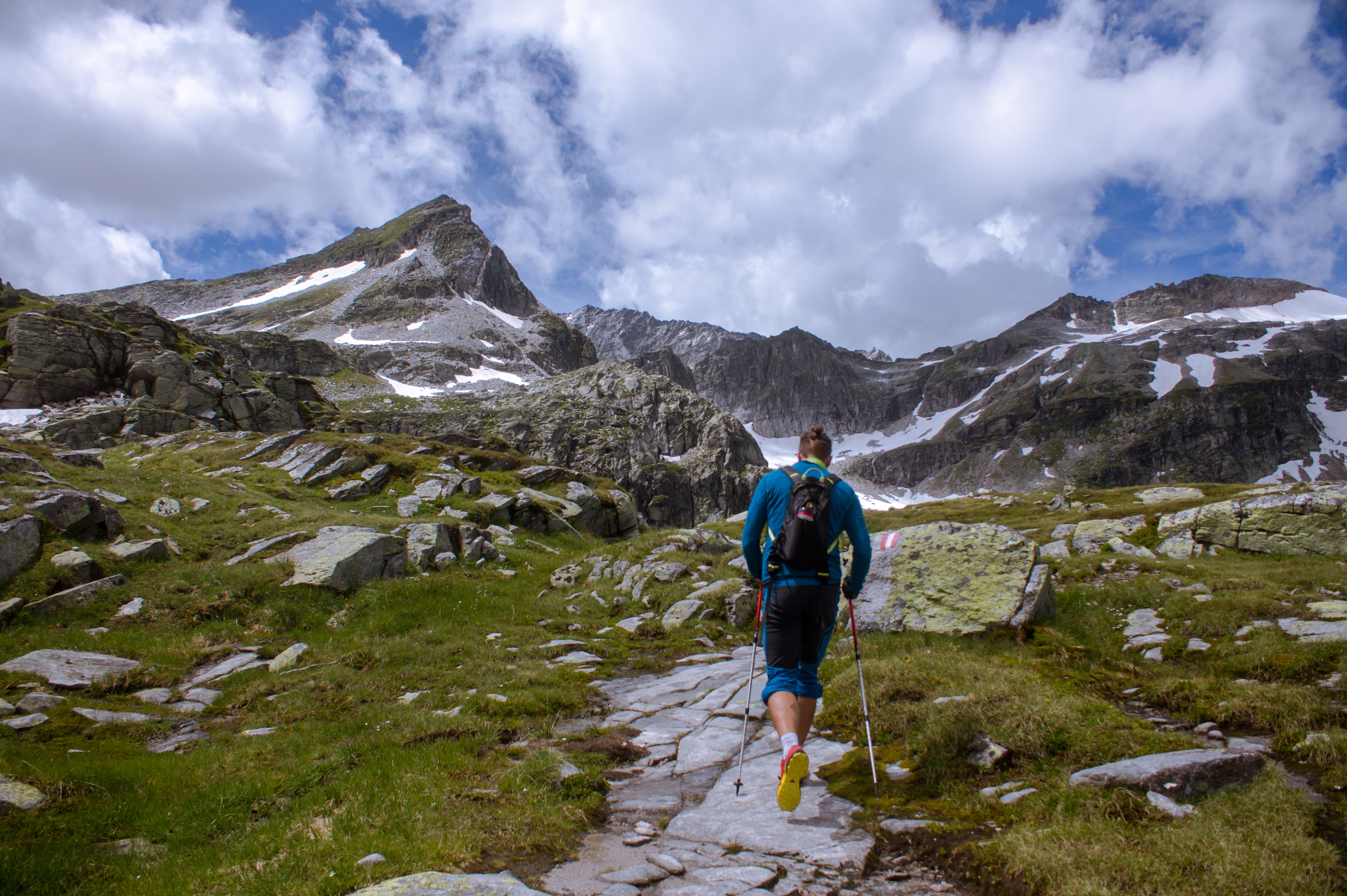 hiking safety in the mountains, man hiking with hiking poles