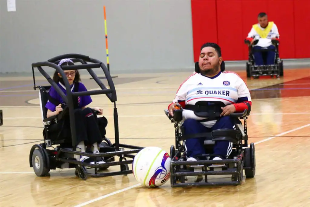 adaptive sport power soccer, two players competing to hit the soccer ball down the court