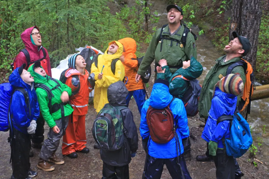 group hiking with essential rain gear 