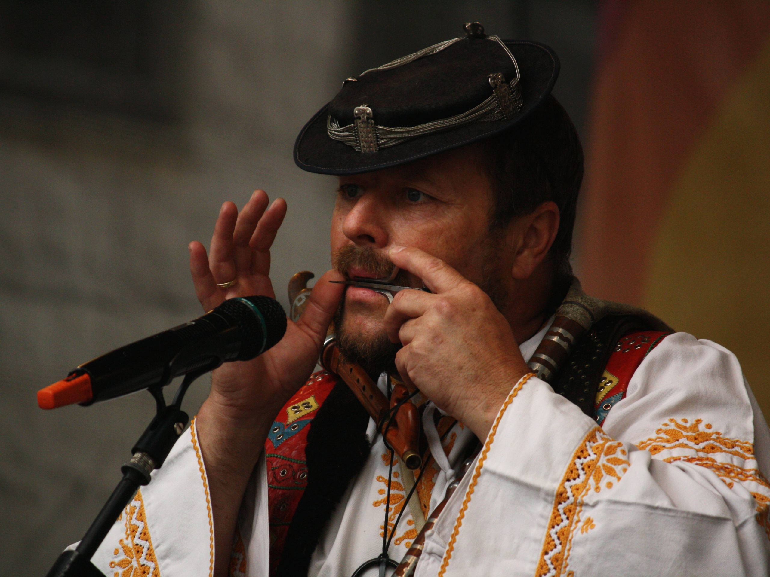 weird musical instrument jaw harp, played by bearded man