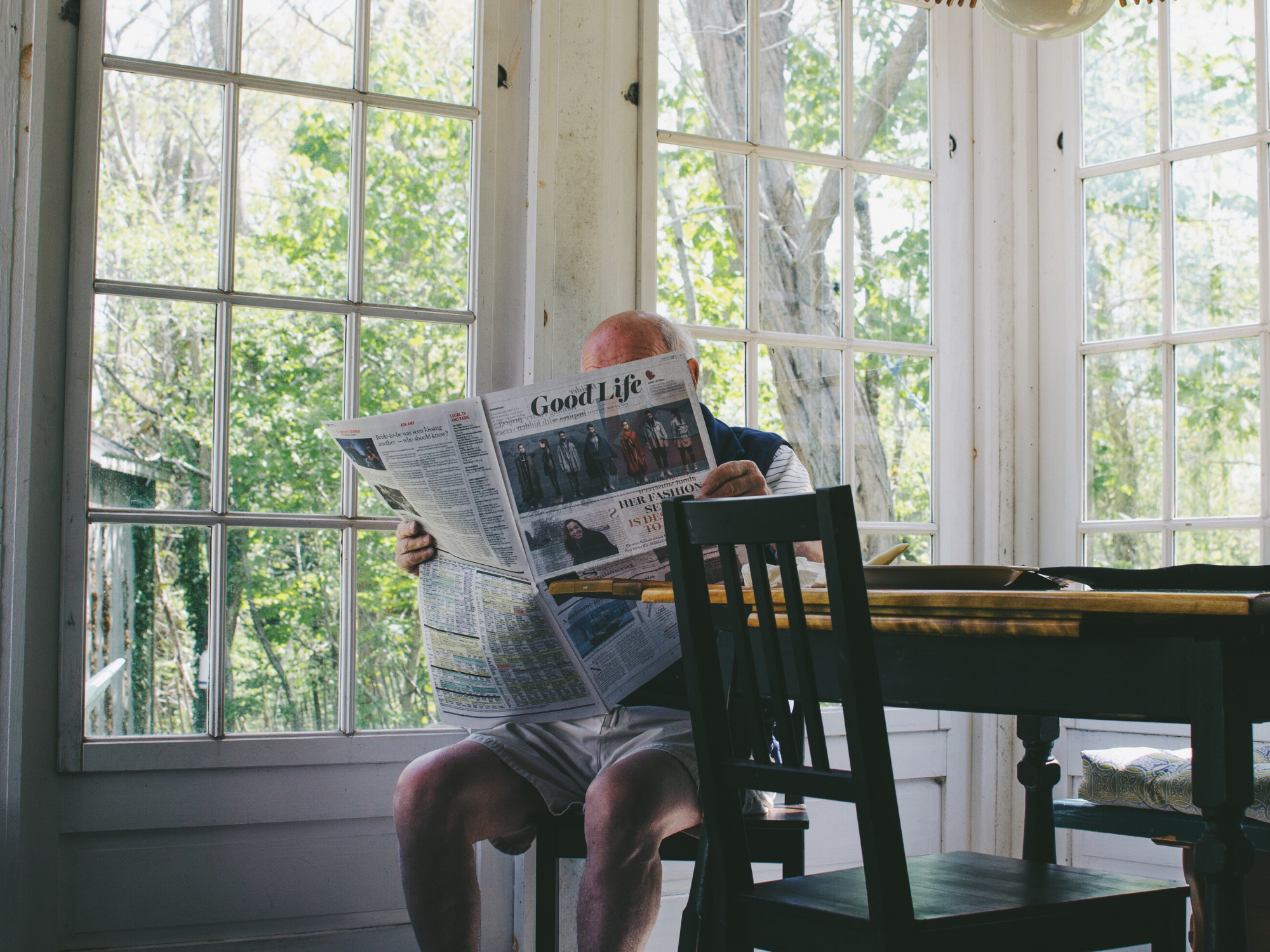hobbies for older men; man reading newspaper