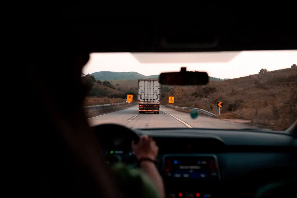 best hobbies for couples, taking a road trip, view from backseat of a car looking down the highway