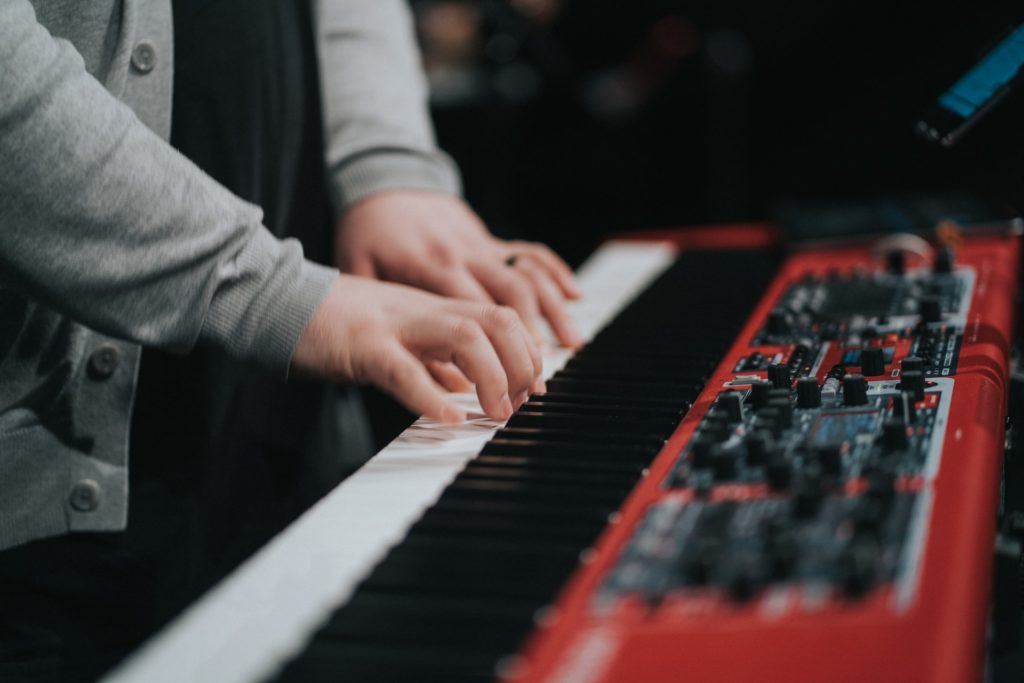 man playing keyboard making music stay at home hobby