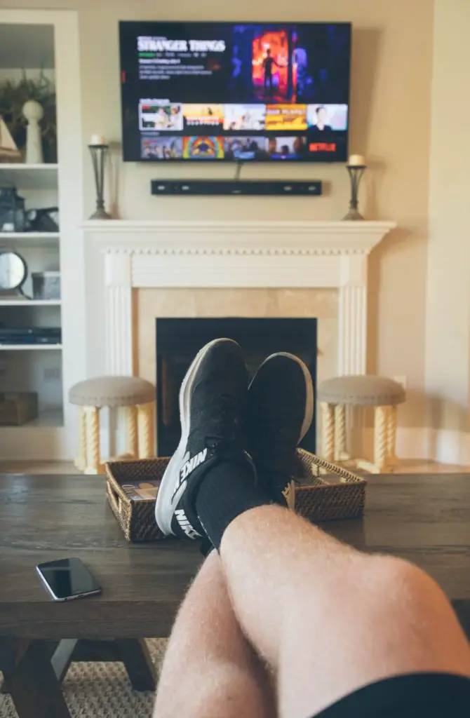 POV man watching tv, home hobbies catching up on favorite television shows