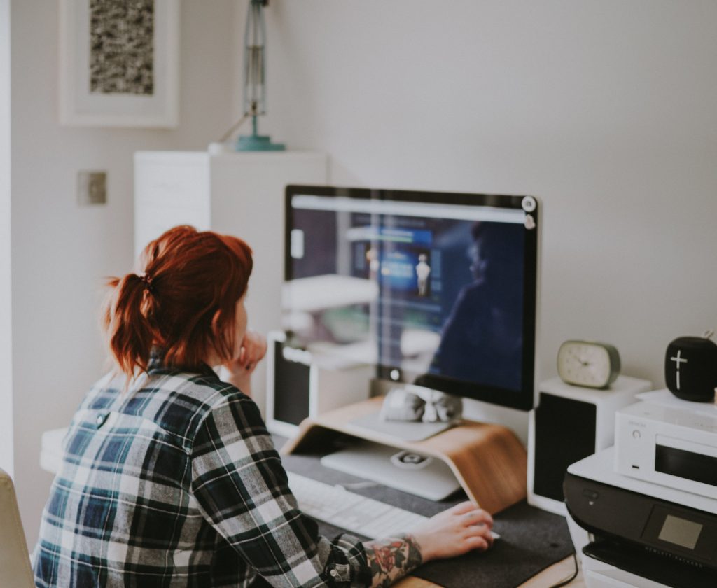 woman sitting at a computer starting a blog / writing