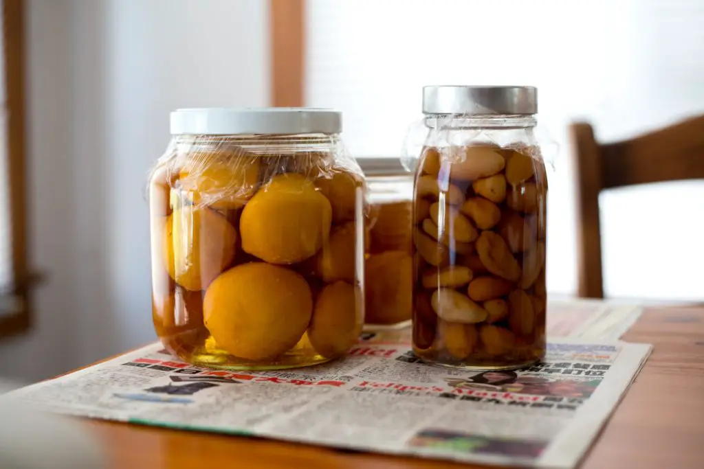 hobby for stay at home moms includes canning and pickling. image of canned vegetables on a wooden table