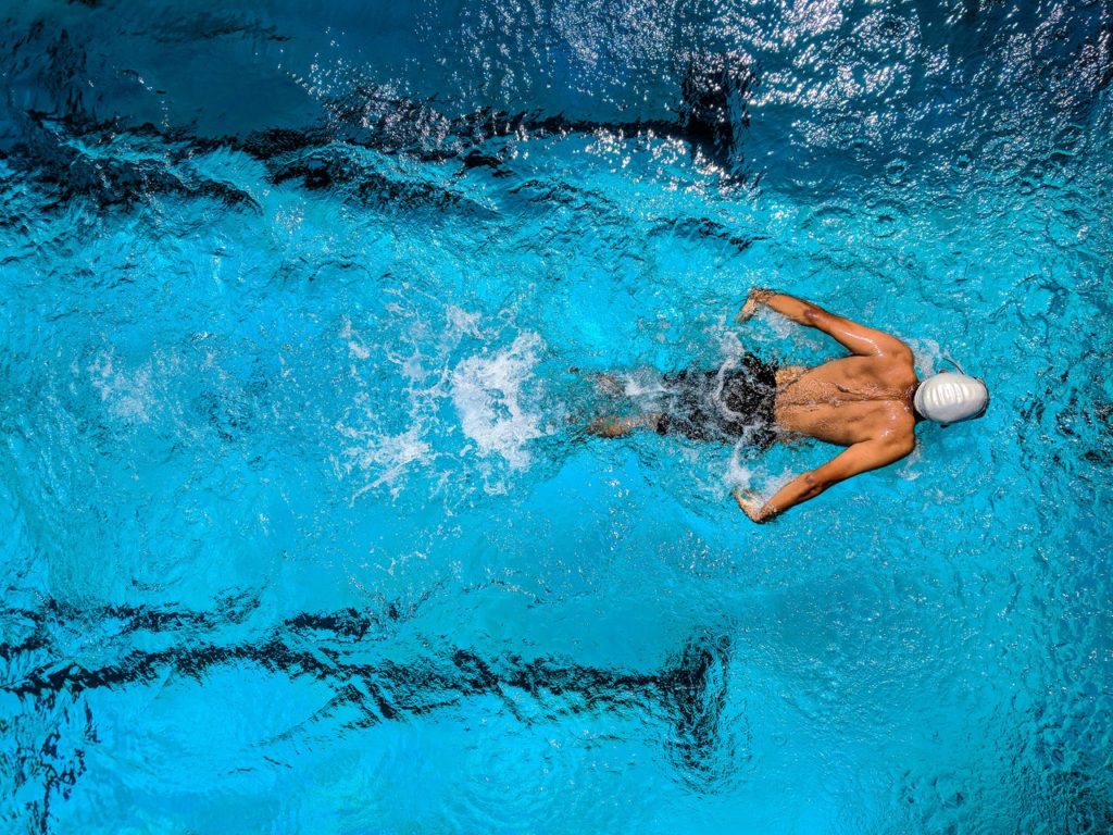 overhead view of man swimming butterfly stroke