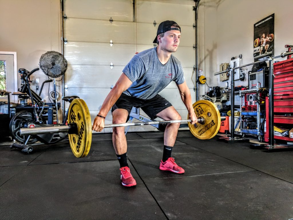 Man dead lifting weights in garage