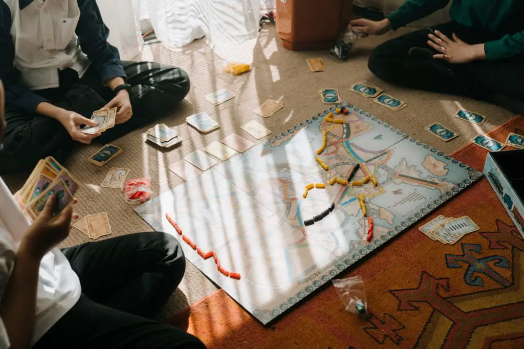 overhead view of board game play, socializing hobbies