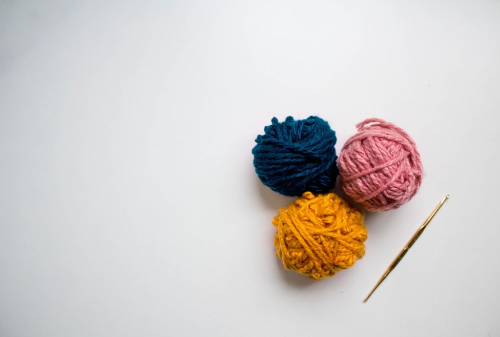 white background with balls of yarn 