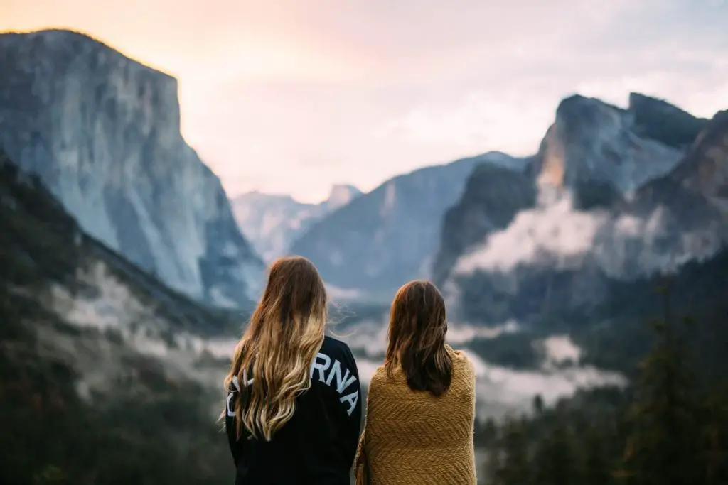 mother and daughter looking over yosemite valley