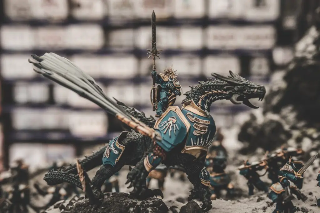 close up of miniature warrior and dragon; painting miniatures hobby to practice patience