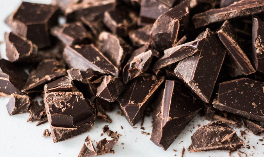 close up of broken pieces of chocolate on white table