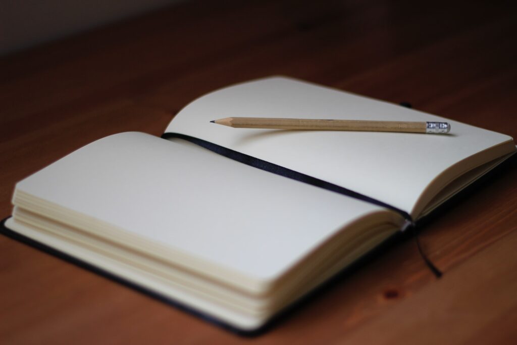 open journal with pencil, writing hobby to make money