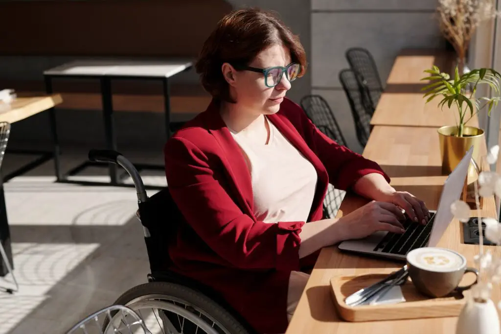 woman in wheelchair on laptop computer taking personality quiz to discover a new hobby