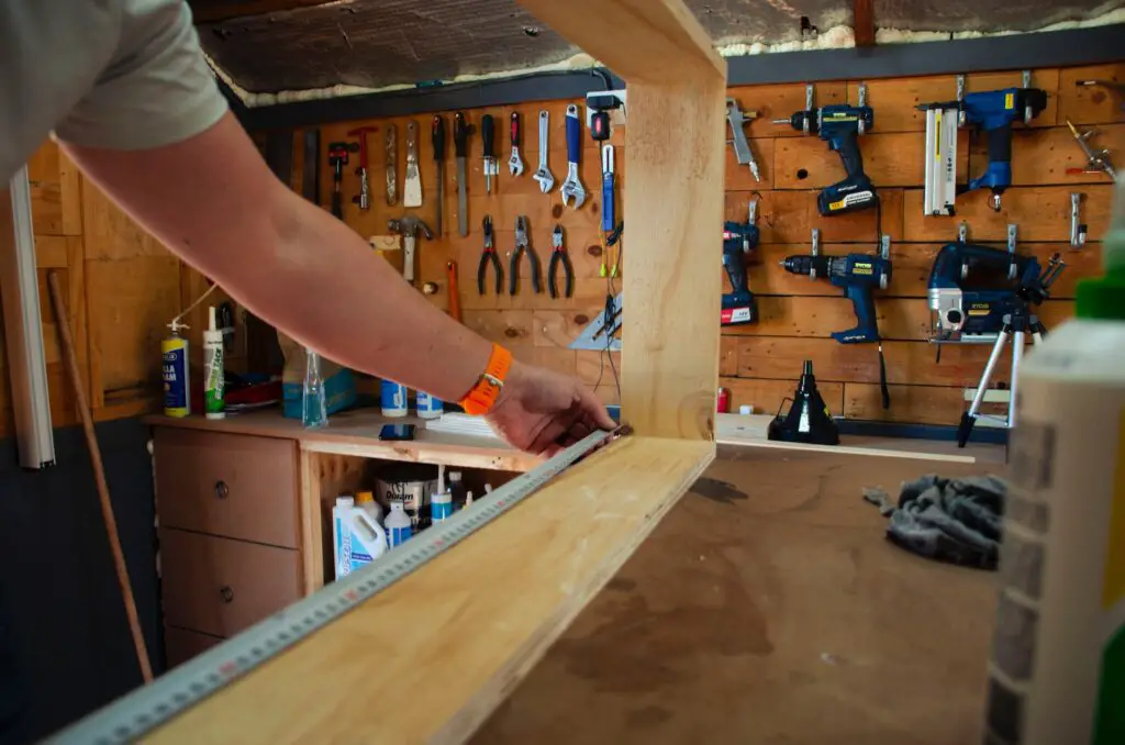 man measure wood in a toolshed; hobbies to work with your hands