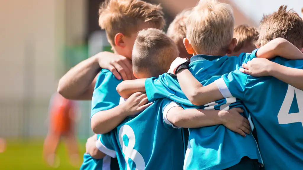 young boys huddle soccer team