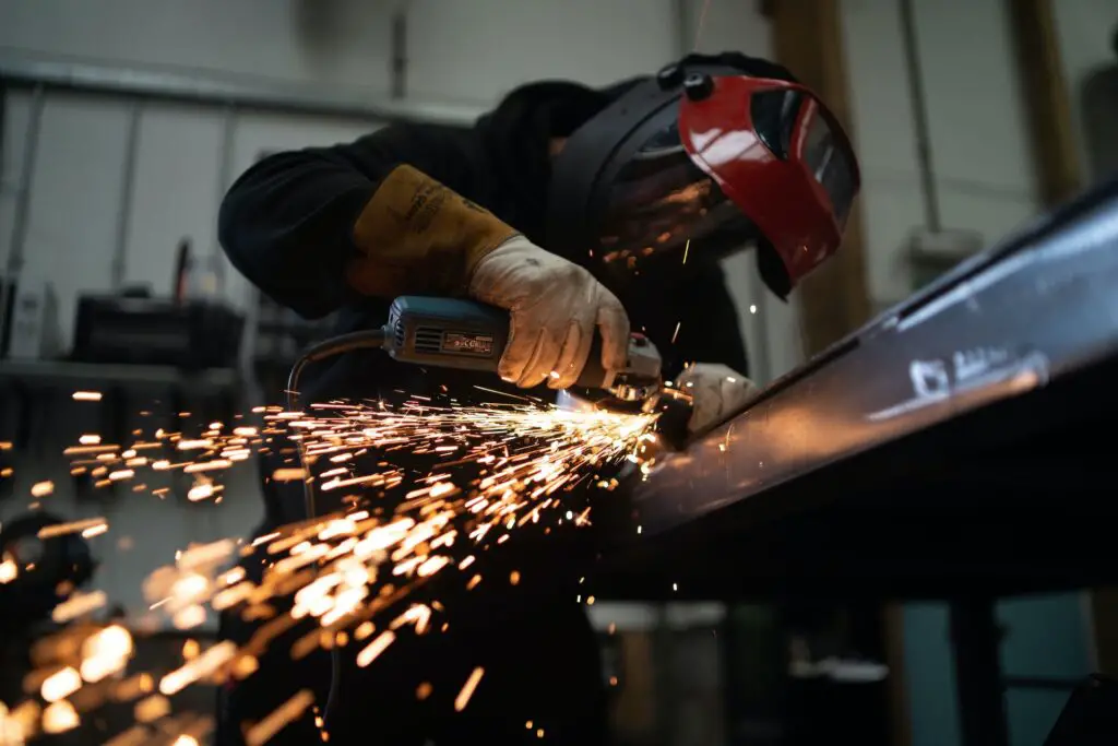 sparks flying from man doing metal work; metalworking hobby