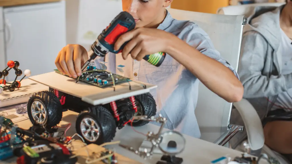 pre-teen boy working on robotics hobby