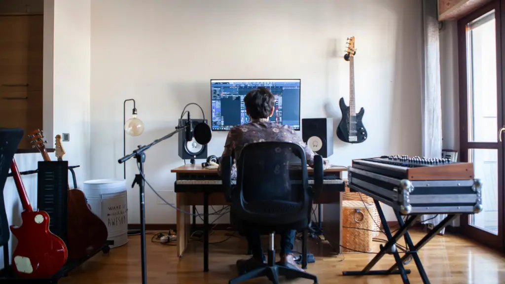 man sitting at desk music production hobby
