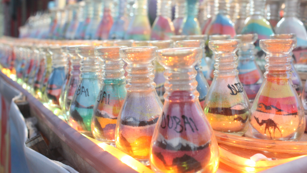 lineup of sand art in glass jars