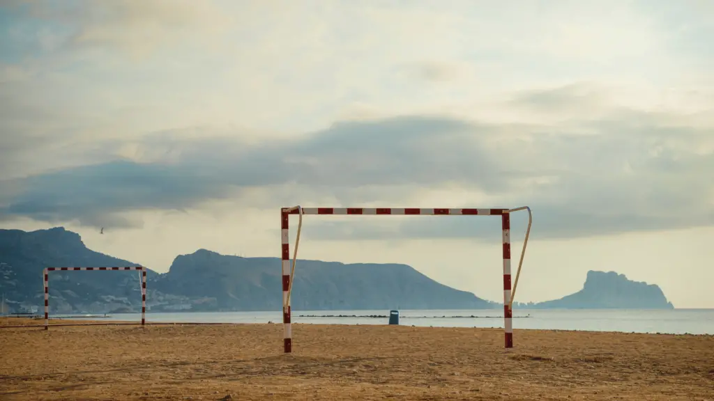 two soccer goal posts on the beach