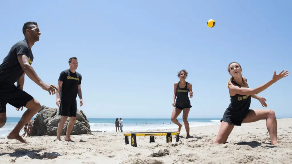 4 people playing spikeball on the beach