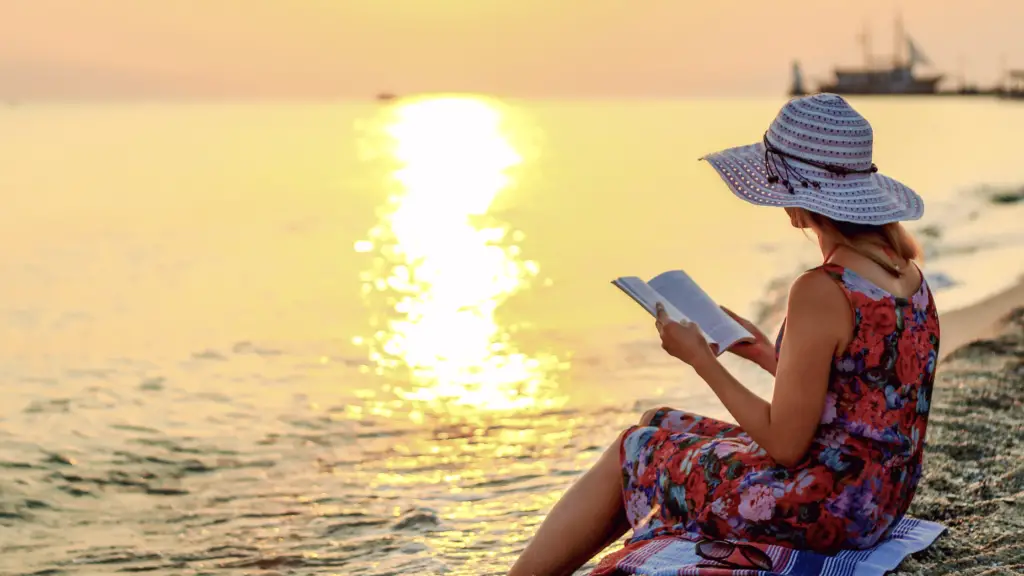 woman reading at the beach at sunset